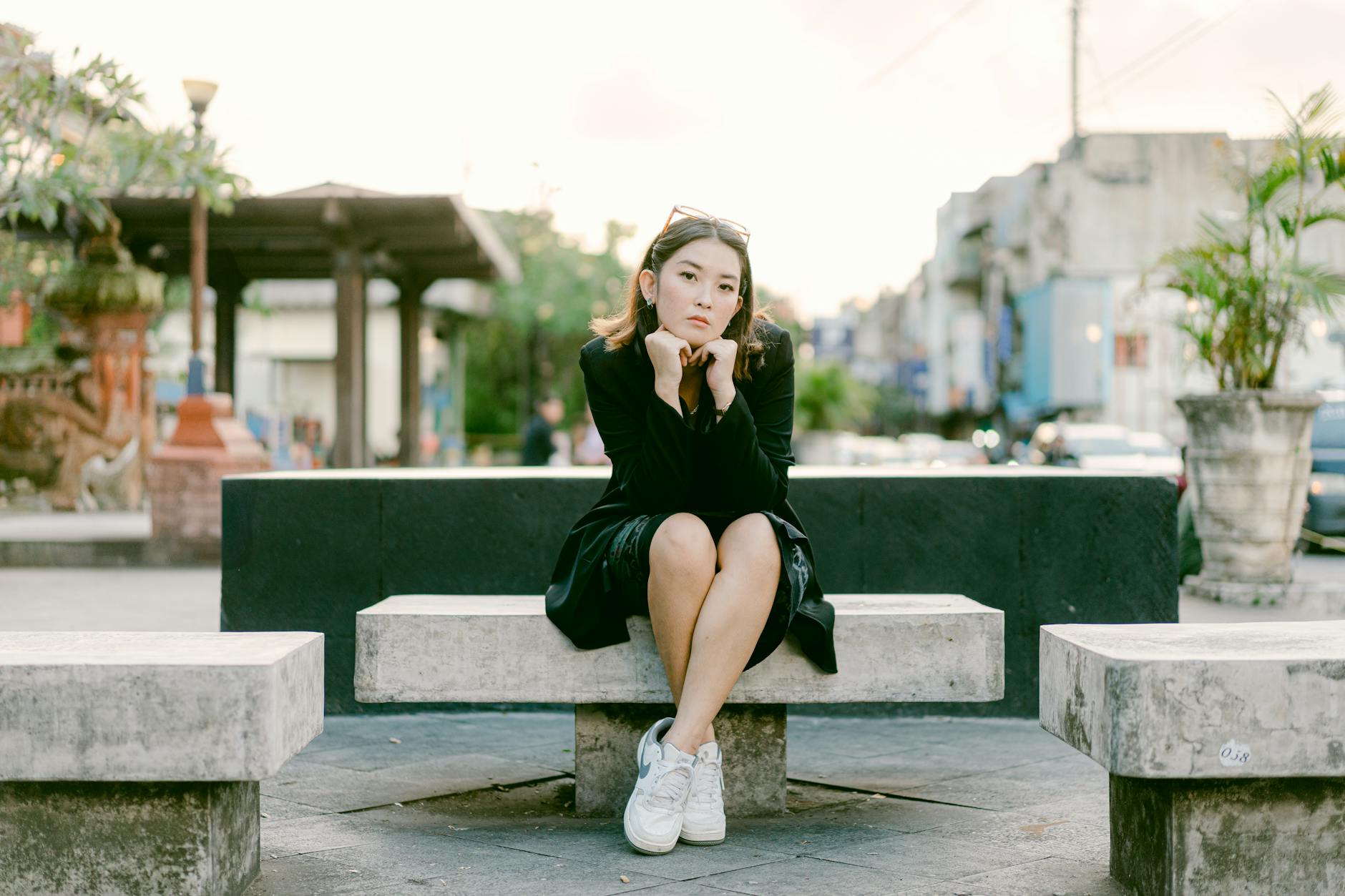 young woman sitting on urban concrete bench